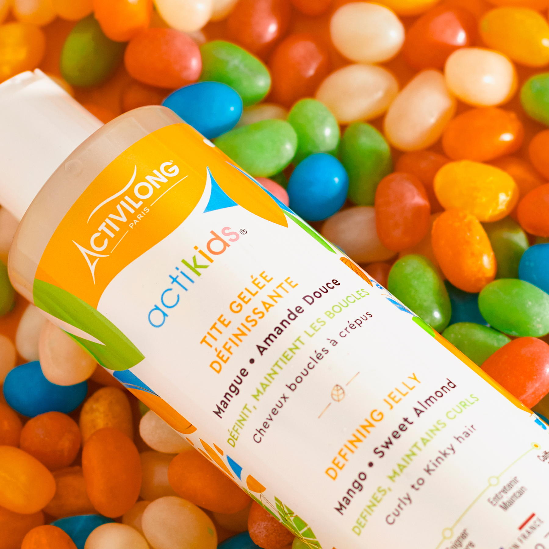 Activilong actikids defining jelly bottle by Afro Beauty Store surrounded by colorful jelly beans