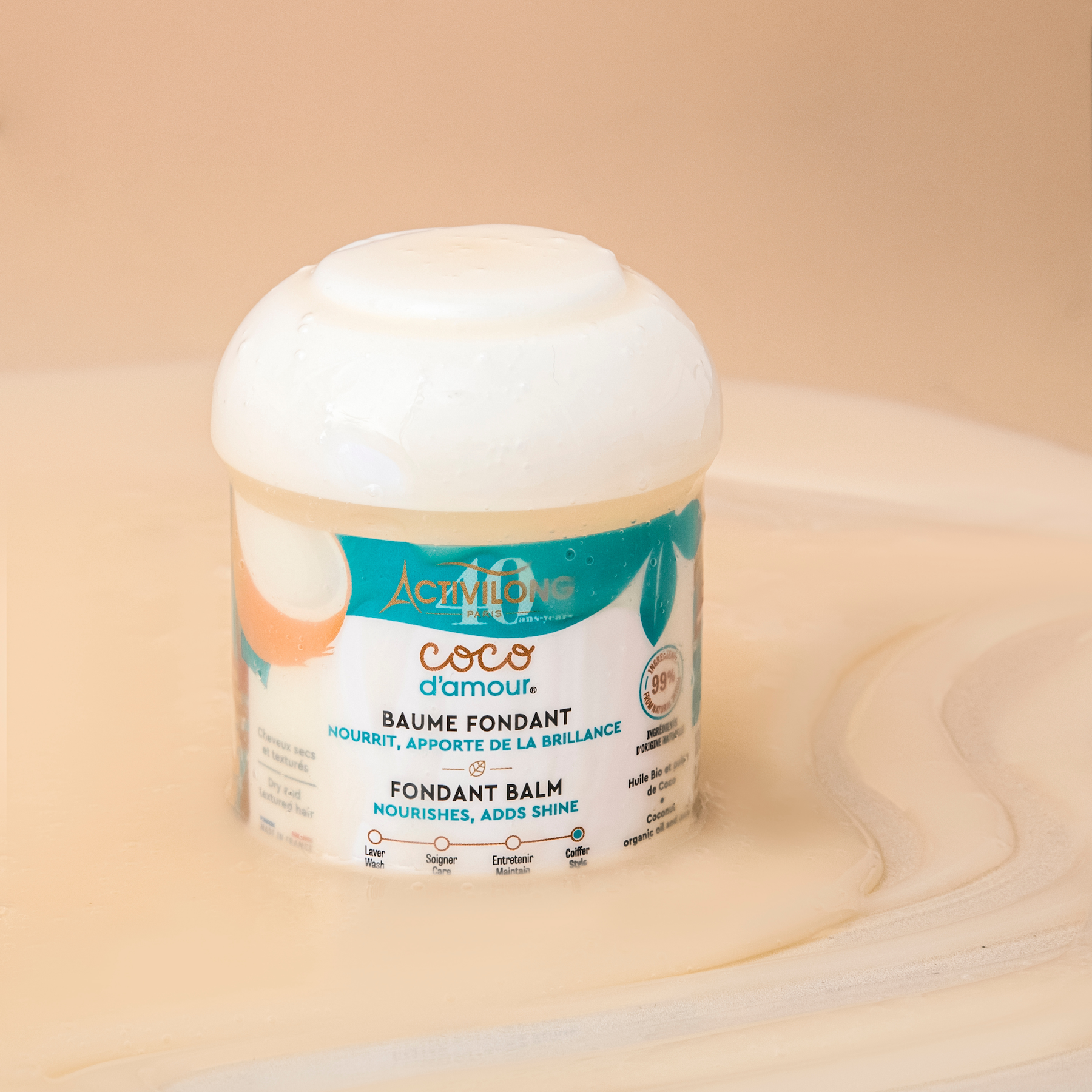 Jar of ACTIVILONG COCO D’AMOUR Baume Coiffant Fondant 100ml by ABS France Wholesale on a beige background