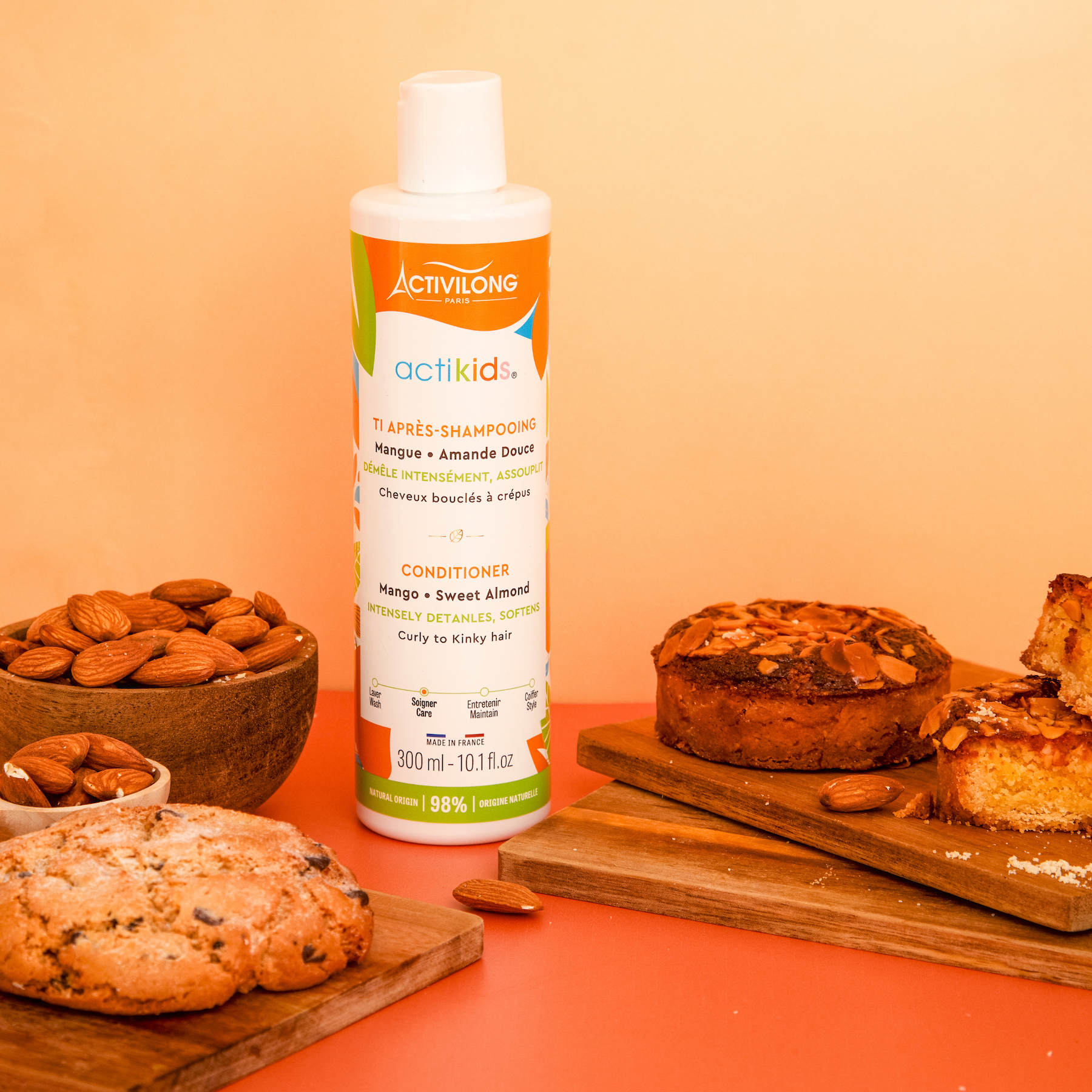 ACTIVILONG ACTIKIDS Conditioner Après-Shampoing 250ml bottle by Afro Beauty Store on a wooden surface with cookies and almonds