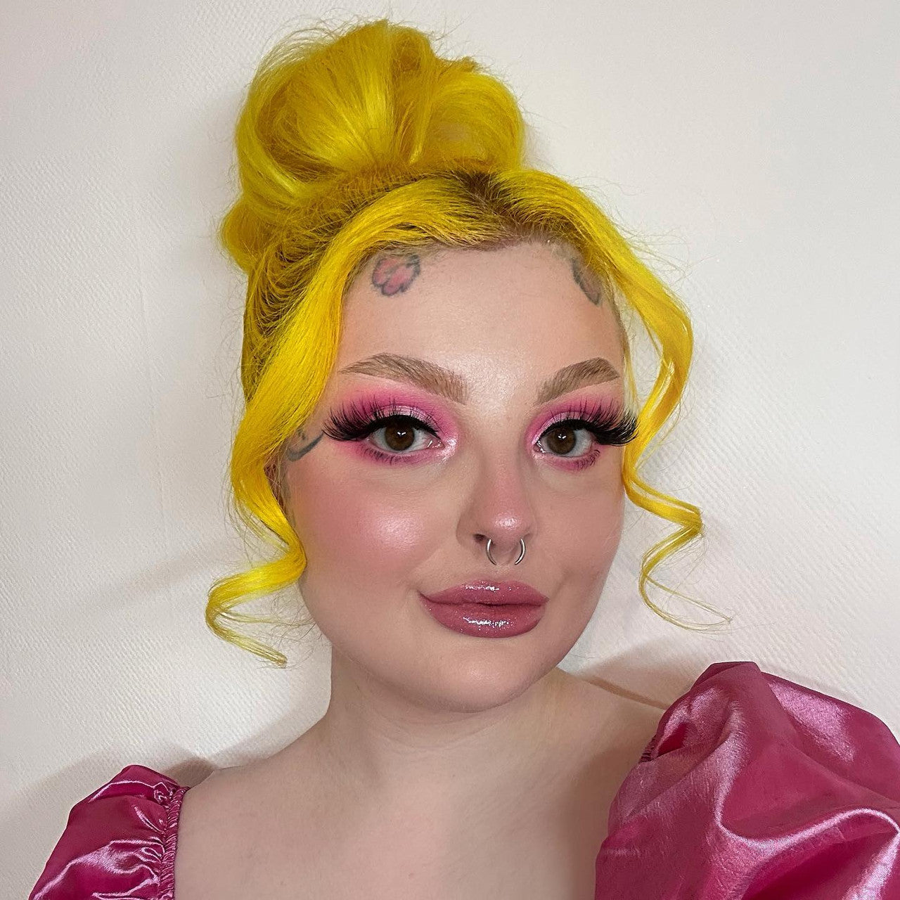 Crazy Color's Person with bright yellow hair and pink makeup wearing a pink top against a white background by Afro Beauty Store