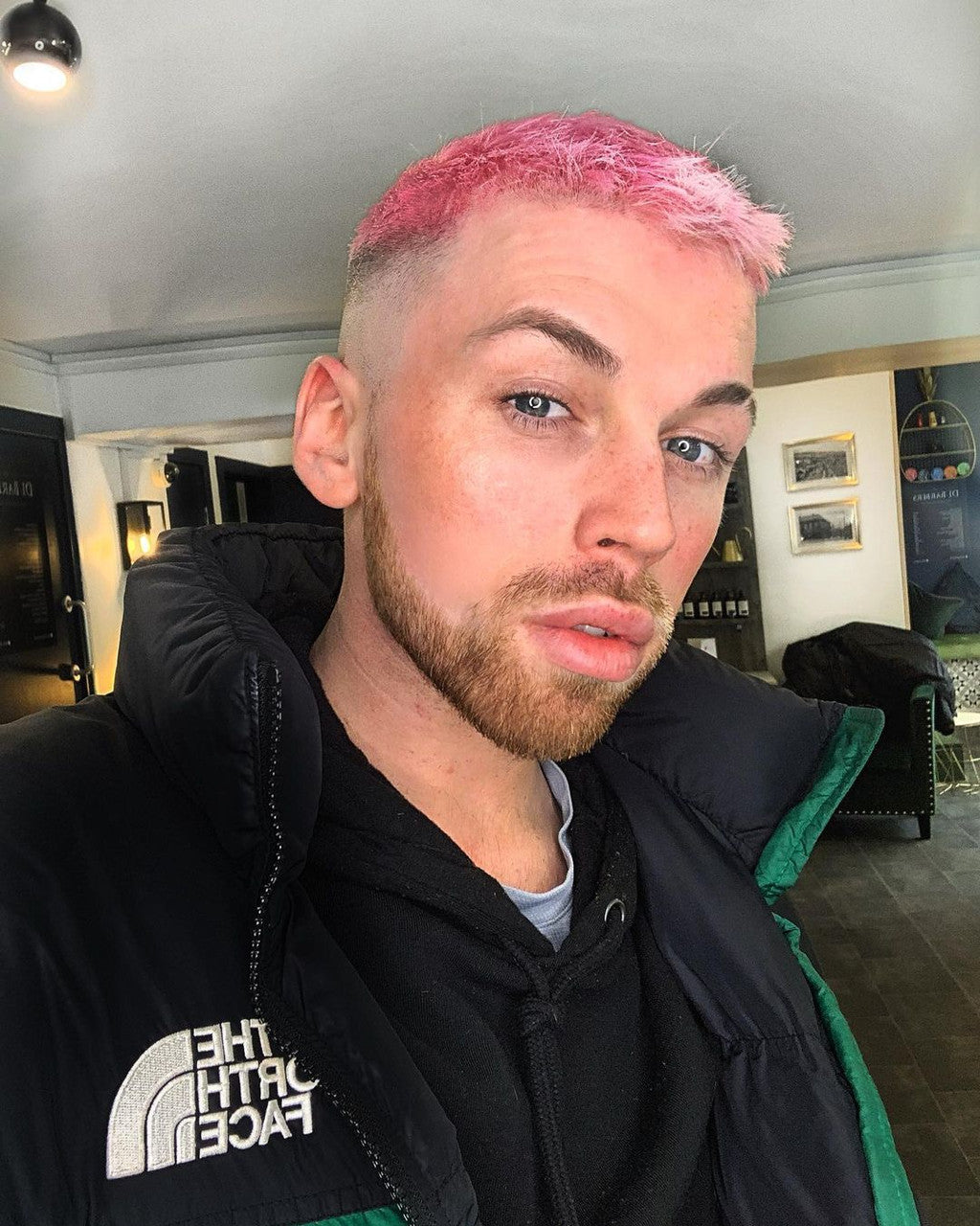 Crazy Color's Person with pink hair wearing a black jacket indoors by Afro Beauty Store