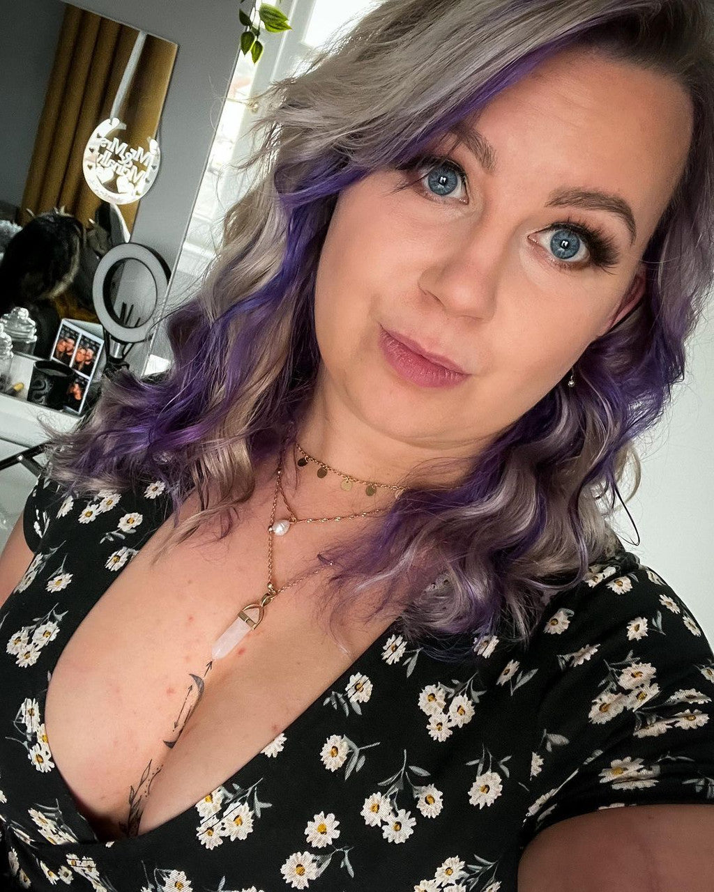 Crazy Color's person with purple hair and floral dress in a room setting by Afro Beauty Store