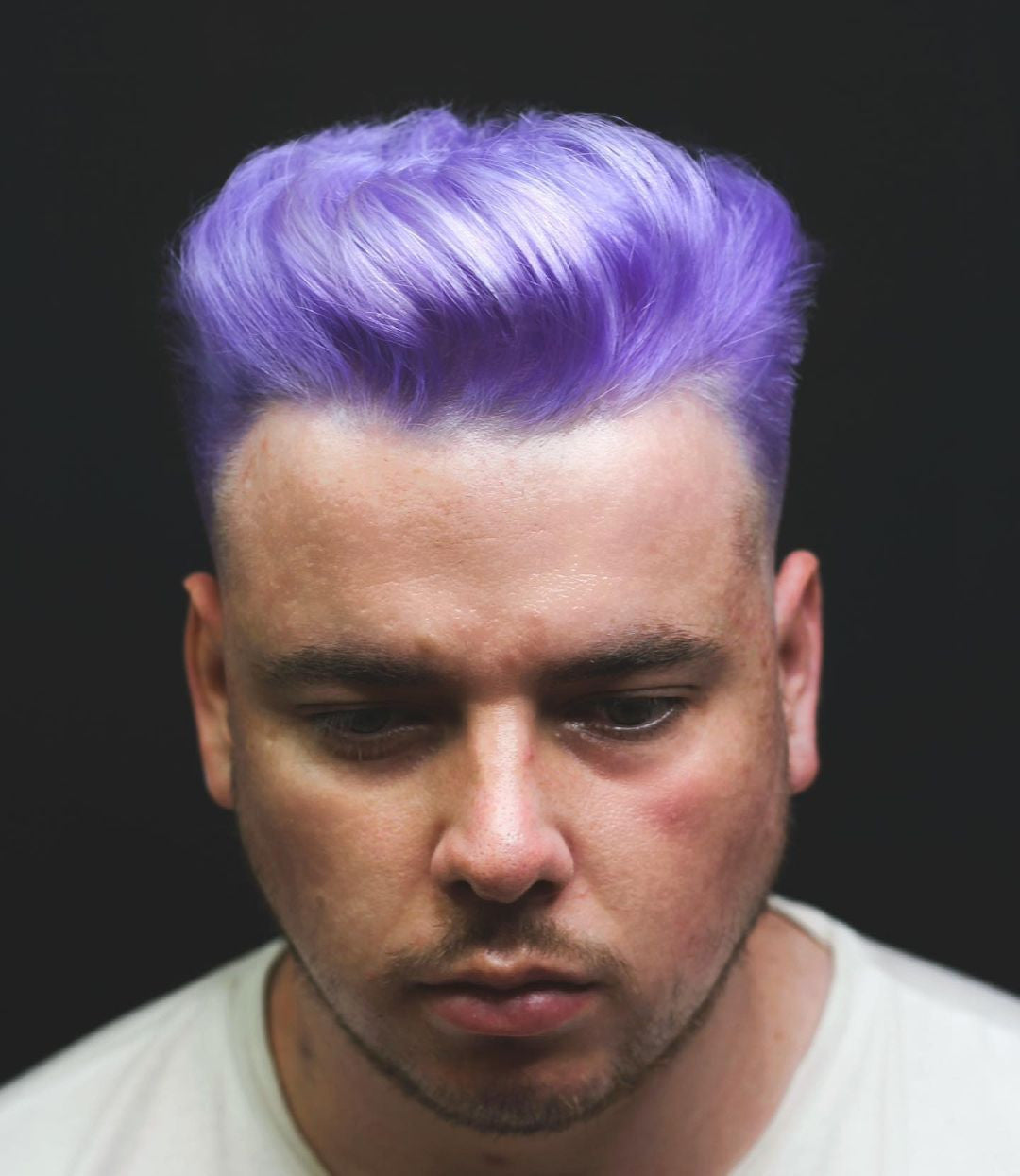 Crazy Color's Person with purple hair against a black background by Afro Beauty Store