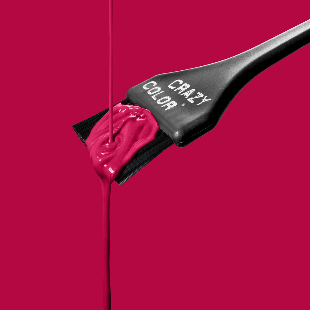 Black hairbrush with Crazy Color Ruby Rouge 66 hair dye on a pink background, featuring the 'Crazy Color' brand by Afro Beauty Store
