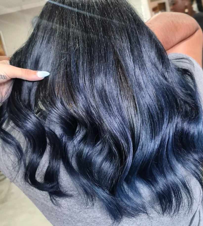 Crazy Color's person Close-up of blue hair extensions being held by a person by Afro Beauty Store