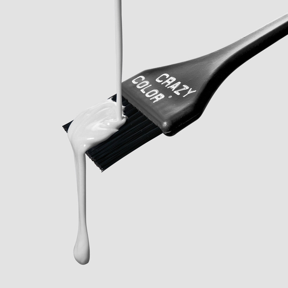 Crazy Color Silver 27 Hair color brush with white dye dripping from it on a light gray background by Afro Beauty Store