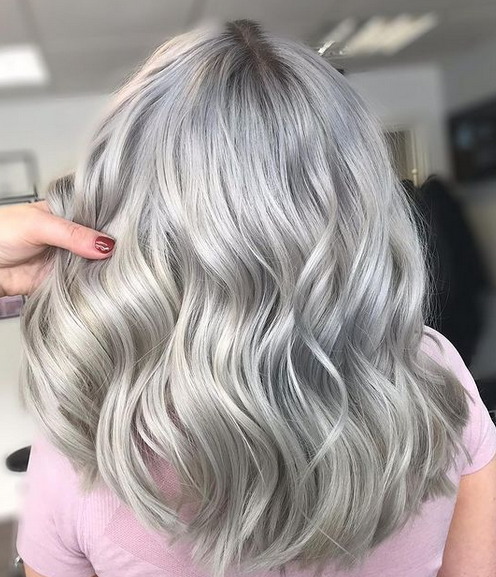 Crazy Color's Person with wavy silver hair in a salon setting by Afro Beauty Store