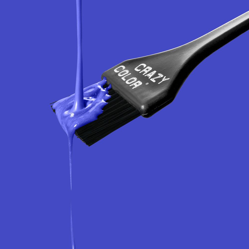 Black hair dye brush with Crazy Color's Sky Blue colorant on a blue background by Afro Beauty Store