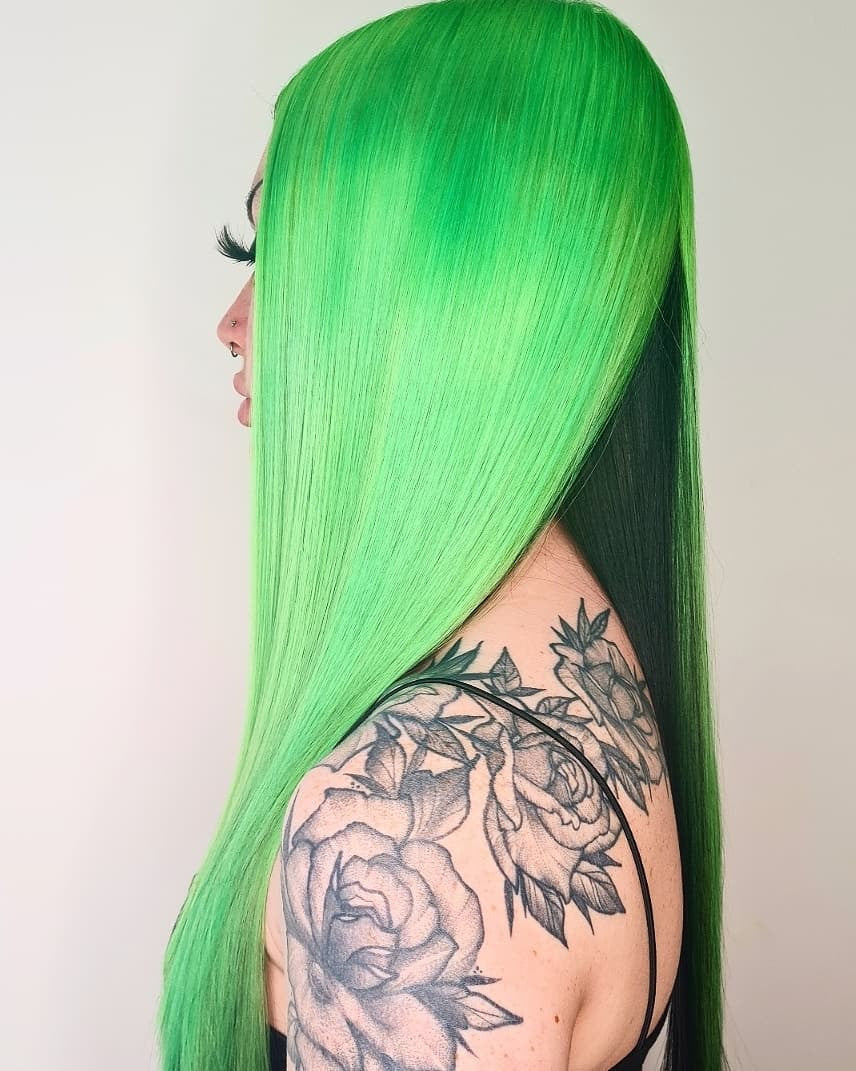 Crazy Color's Person with bright green hair and tattoos on shoulder against a plain background by Afro Beauty Store