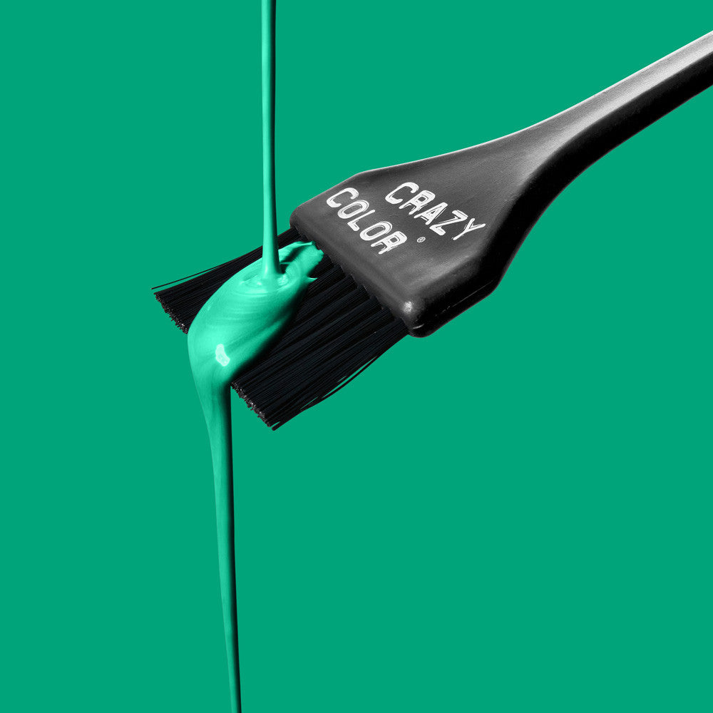 Black Hair dye brush with Crazy Color's emerald green color dripping from it on a green background by Afro Beauty Store