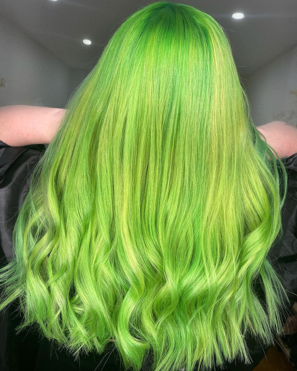 Crazy Color's Person with vibrant green hair in a salon setting by Afro Beauty Store
