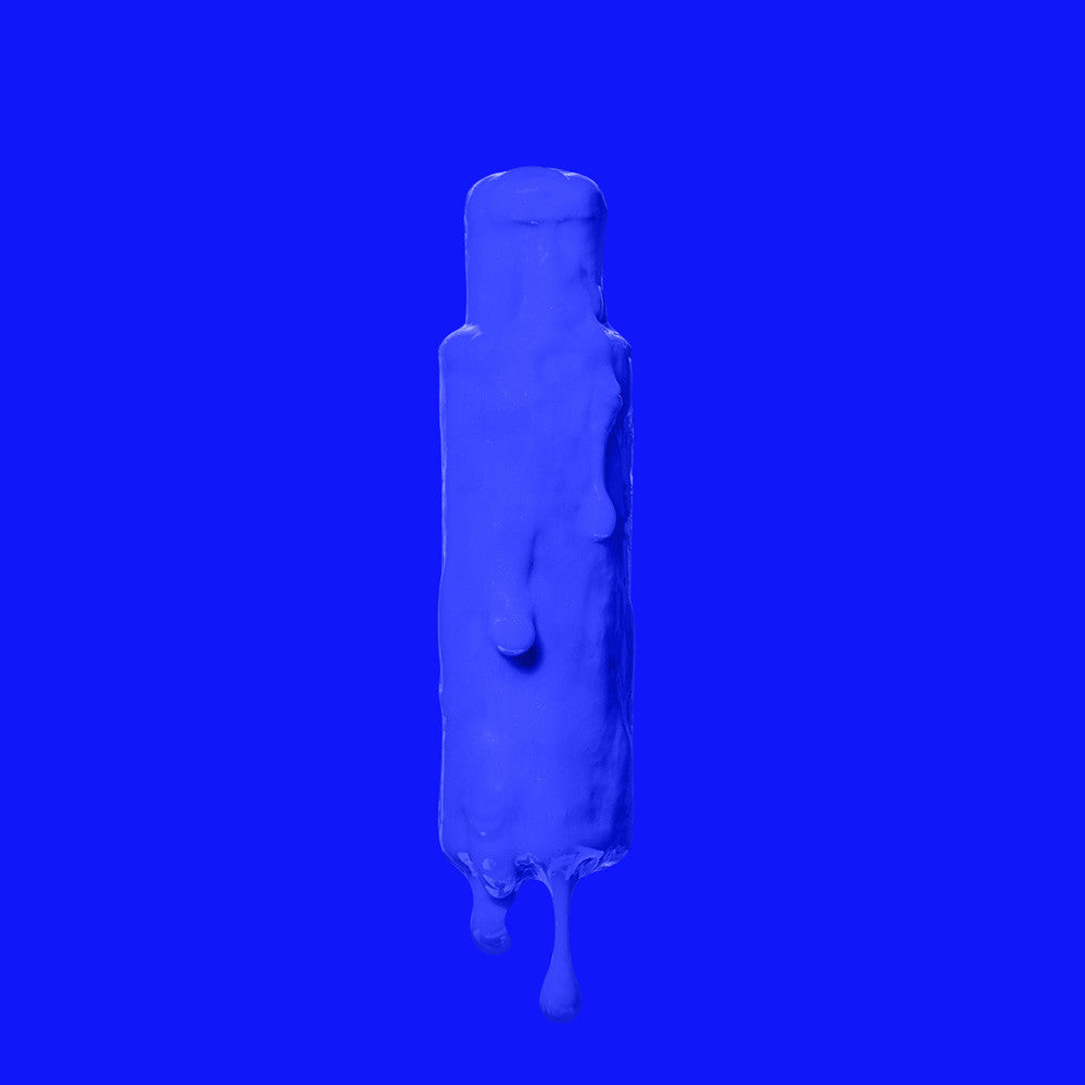 Crazy Color's Capri Blue bottle with a droplet effect on a blue background by Afro Beauty Store