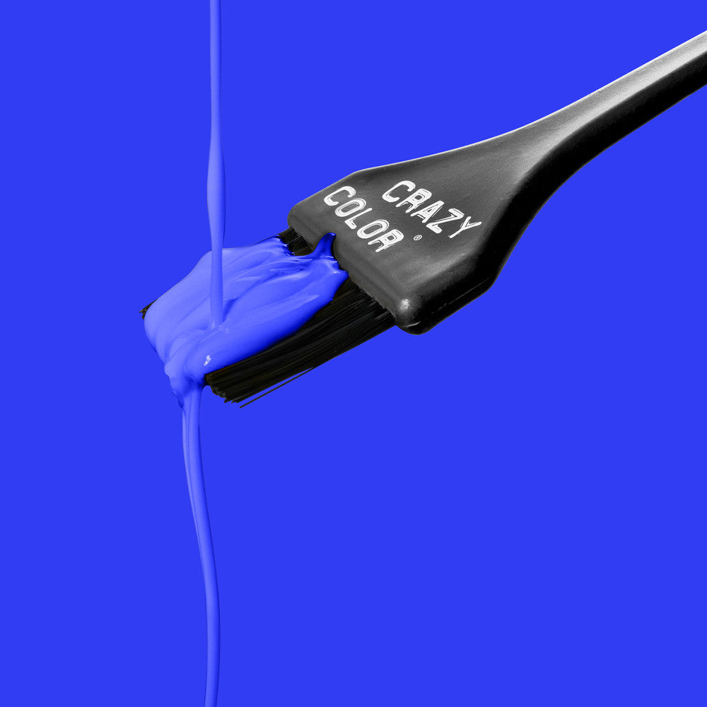 Blue paint being applied with a brush labeled 'Crazy Color' on a blue background by Afro Beauty Store