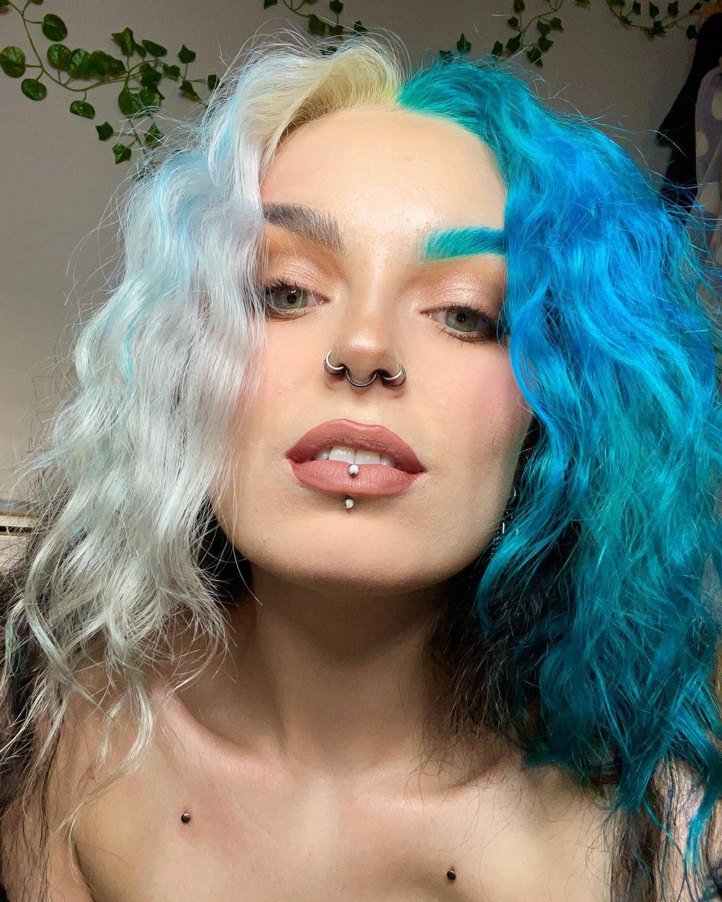 Crazy Color's Person with half white and half blue hair, wearing a nose ring and lip piercings by Afro Beauty Store