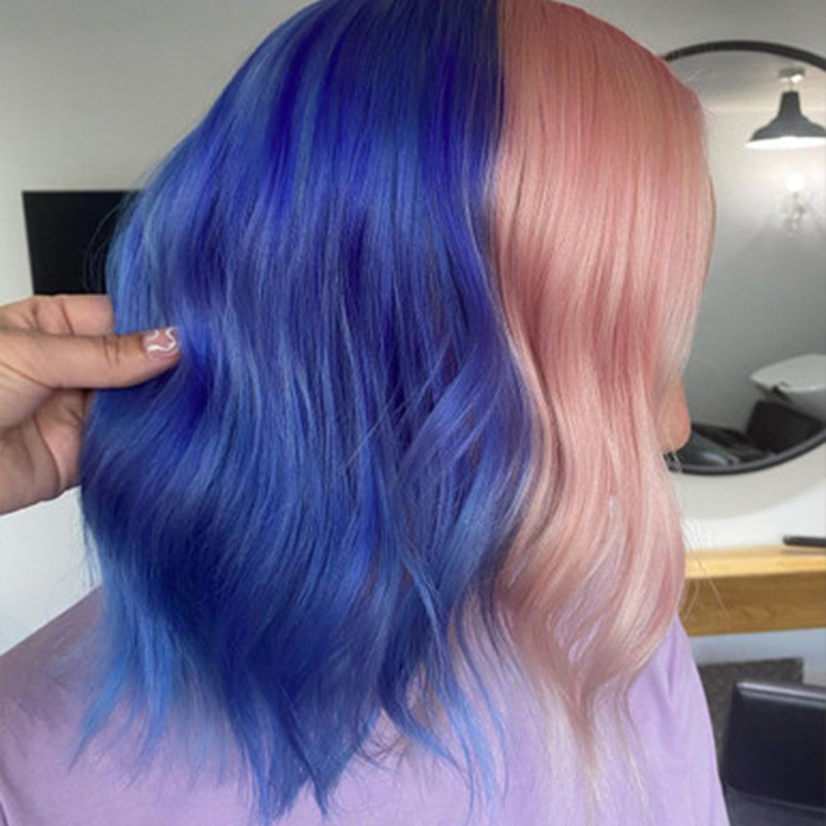 Crazy Color's Person with blue and pink hair in a salon setting by Afro Beauty Store