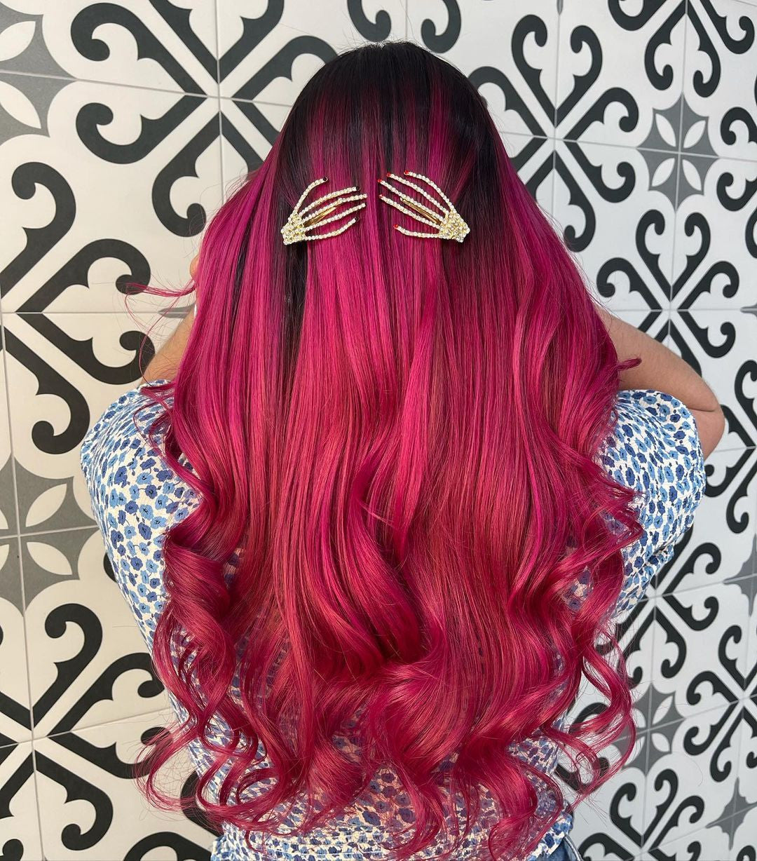 Crazy Color's Person with vibrant pink hair wearing gold hair clips against a patterned wall - Afro Beauty Store