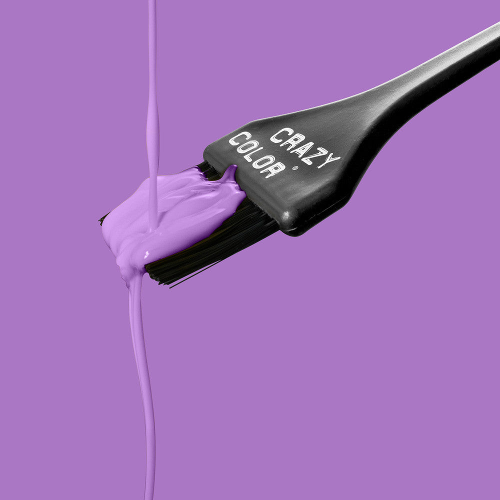 Hair dye brush with Crazy Color Lavender no. 54 colorant on a purple background, featuring the brand 'Crazy Color' by Afro Beauty Store