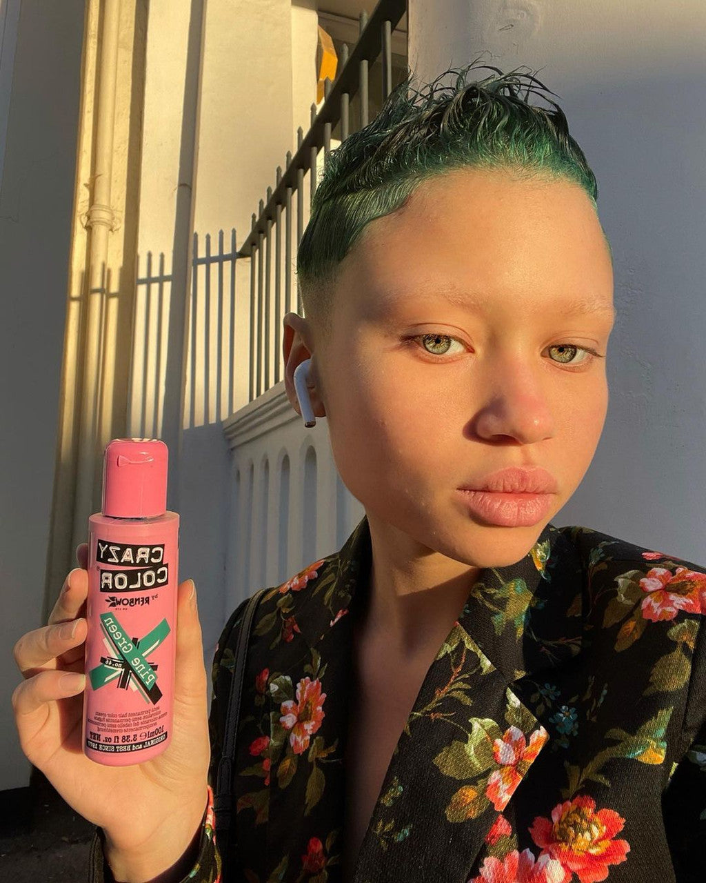 Person with Green Hairs holding Crazy Color Pine green Hair Dye product by Afro Beauty Store
