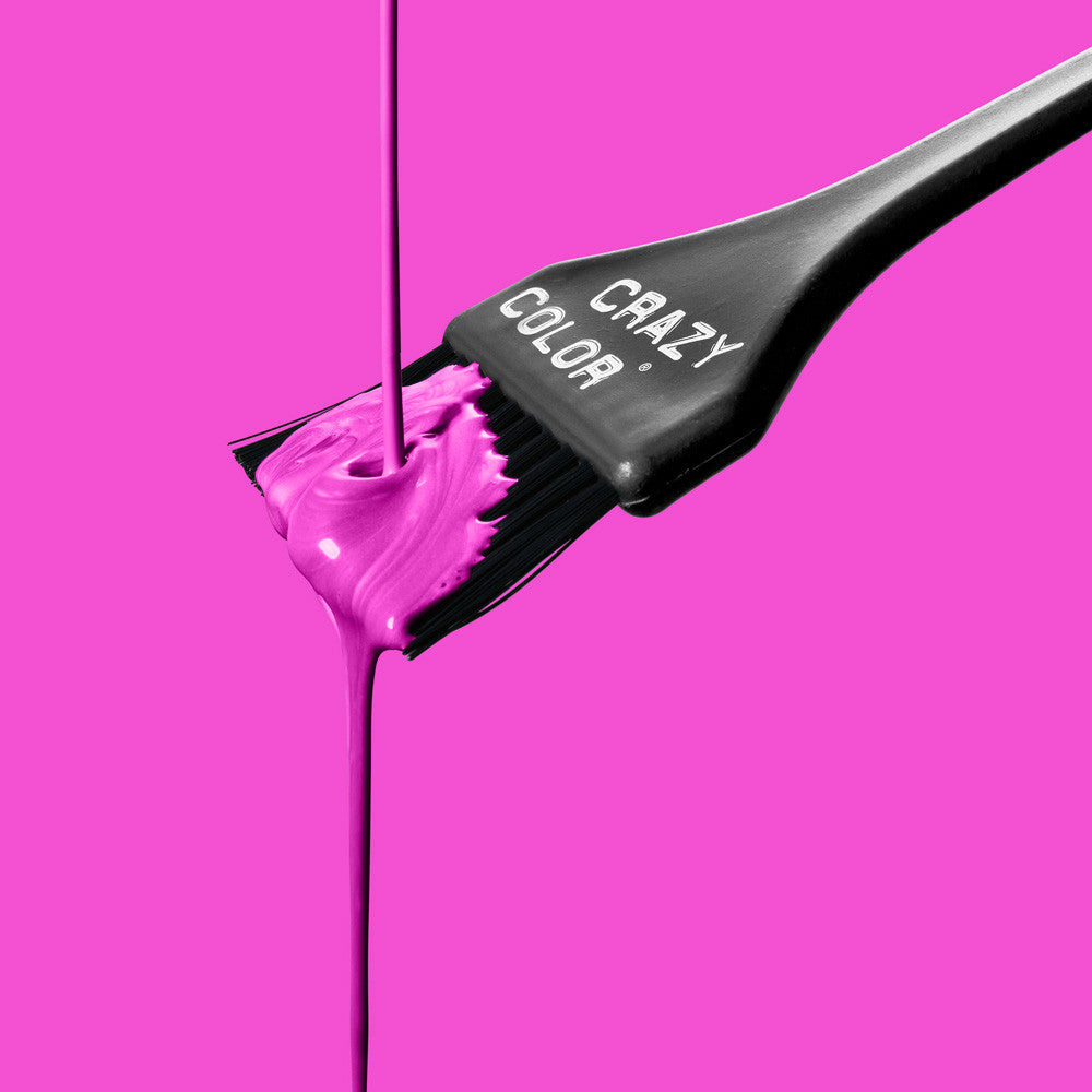 Hair dye brush with pink color on a bright pink background, featuring the brand 'Crazy Color' by Afro Beauty Store