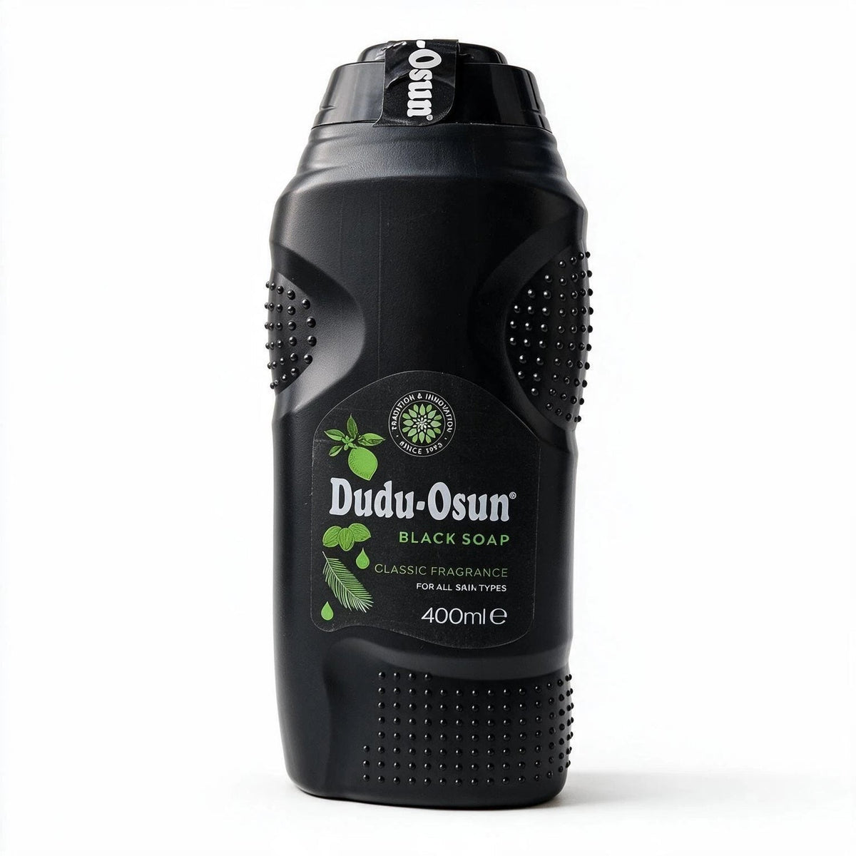 A 400ml black bottle of Dudu-Osun Black Soap Classic Fragrance, featuring a textured black plastic body with green botanical illustrations on the label, set against a plain white background.