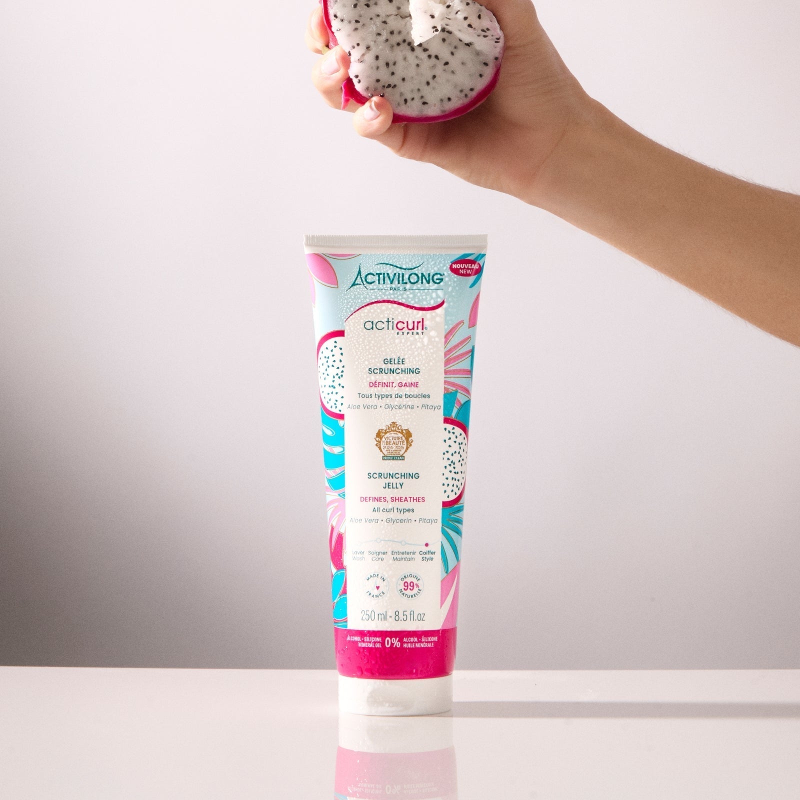 ACTIVILONG ACTICURL EXPERT Gelée Scrunching 250ml by Afro Beauty Store with a hand holding a dragon fruit against a gradient background