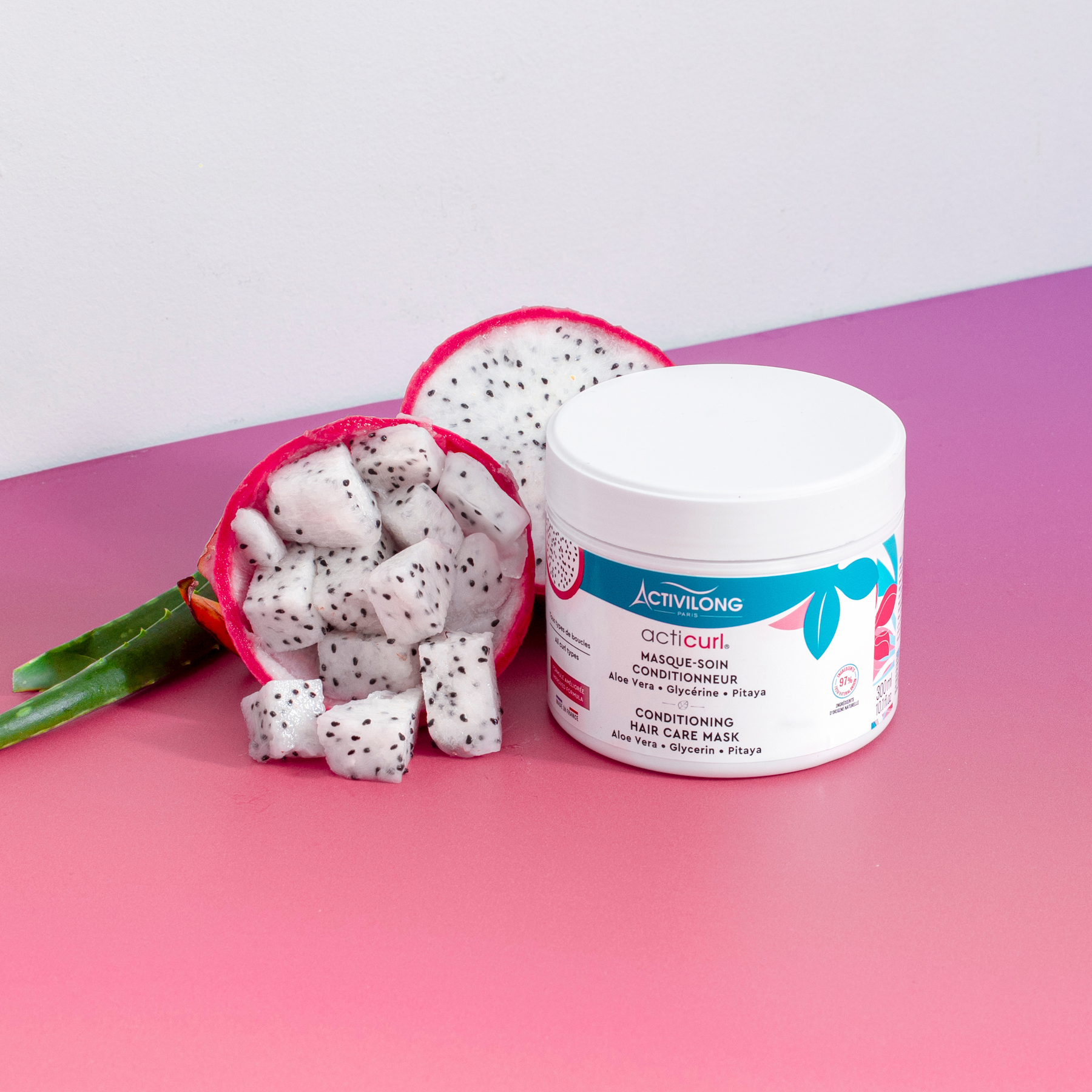 ACTIVILONG ACTICURL Masque 300ml jar by Afro Beauty Store with dragon fruit on a pink surface