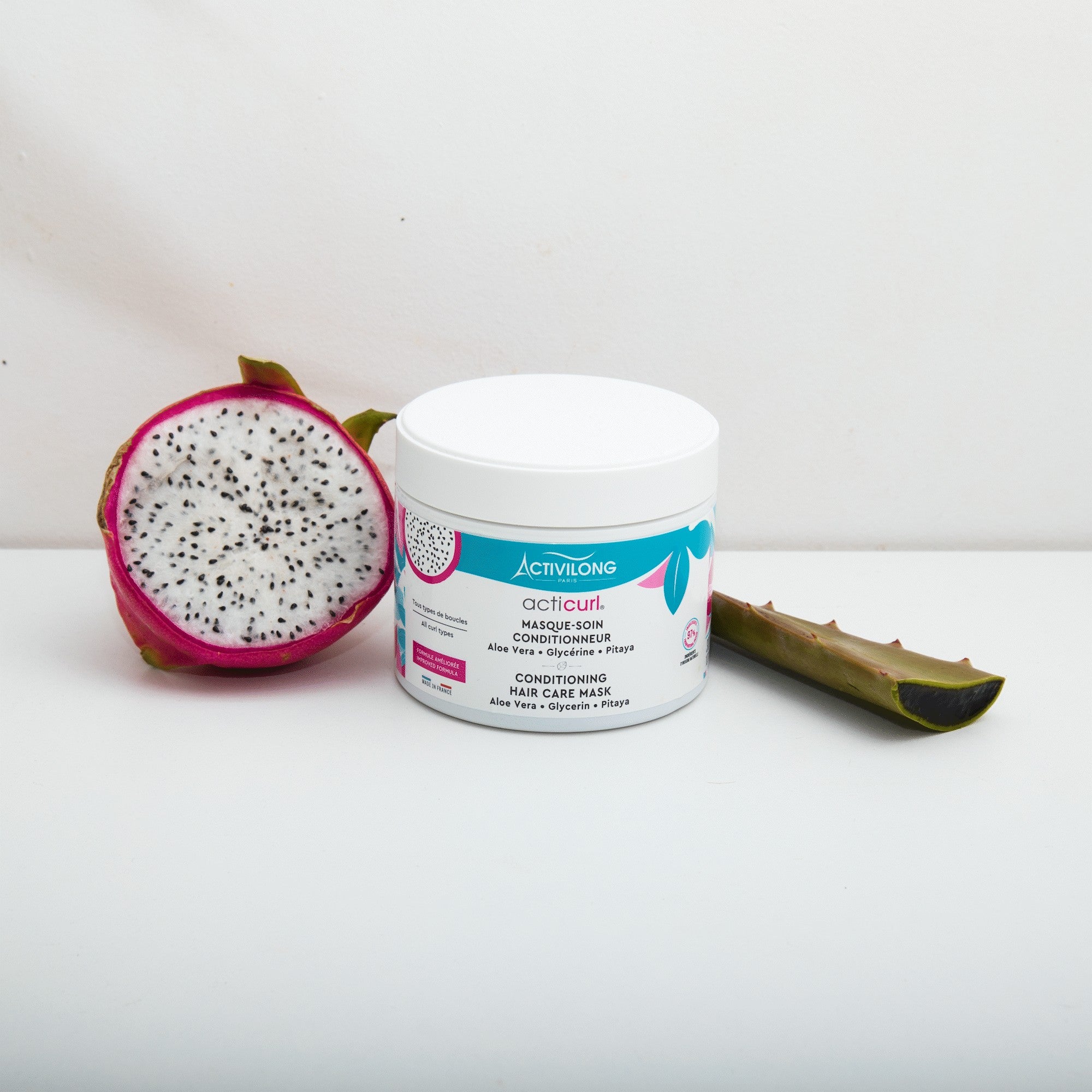 ACTIVILONG ACTICURL Masque 300ml jar by Afro Beauty Store with a half-cut dragon fruit and aloe vera leaf on a white background